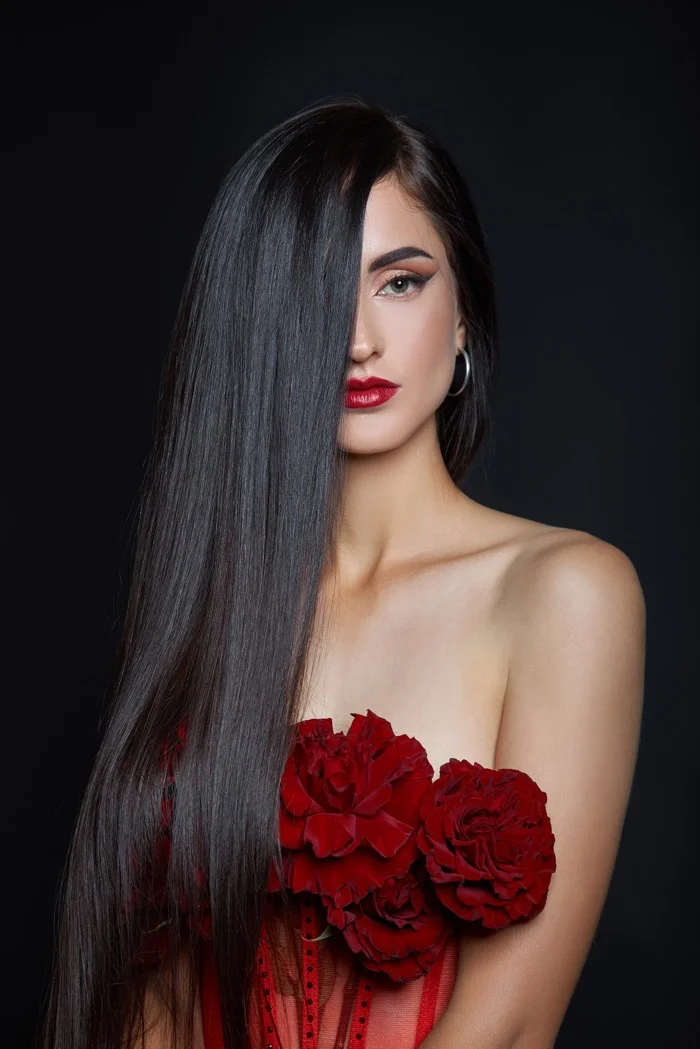 Woman with long sleek straight dark hair showing smooth keratin treatment results at RH Beauty Lounge in Las Vegas