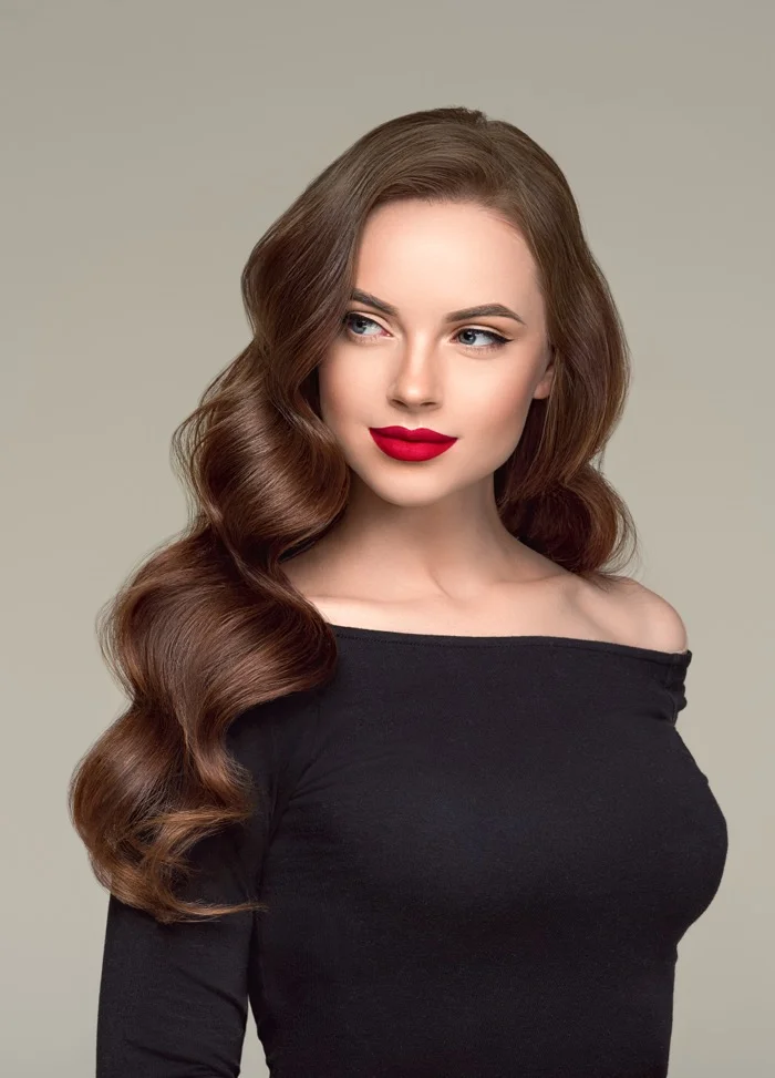 Woman with long soft brunette beach waves styled in loose polished curls at RH Beauty Lounge in Las Vegas