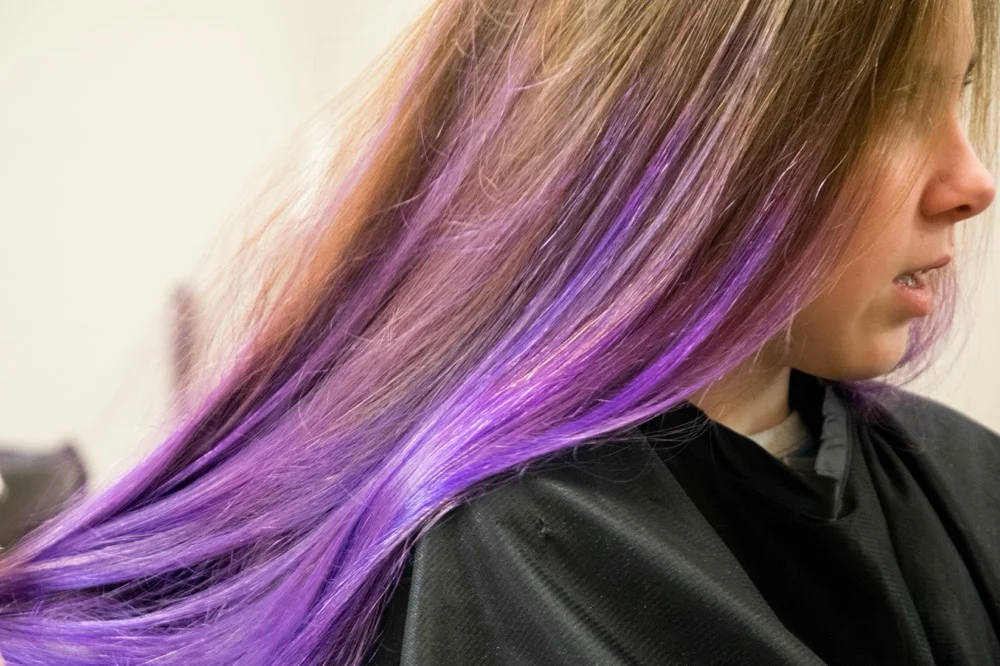Professional balayage hair coloring technique showing dimensional blonde and caramel tones